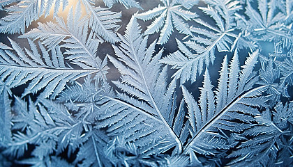 Patterns of frost on a window on a winter morning.