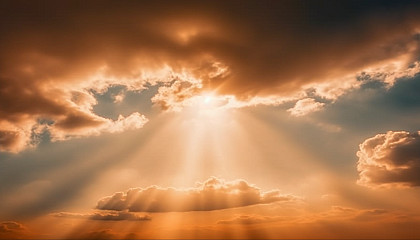 Rays of sunlight piercing through a cloud-covered sky.