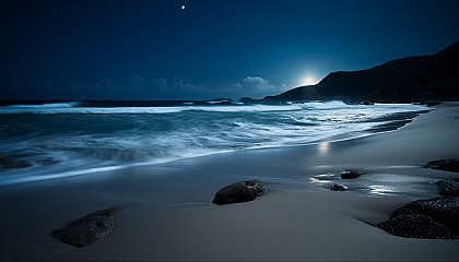 Moonlit nights illuminating tranquil beaches with waves gently lapping the shore.