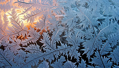 Patterns of frost on a window on a winter morning.