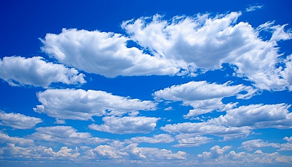 Wispy cloud formations high in a bright blue sky.